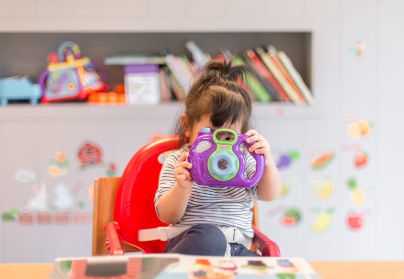 Child sorting colorful beads into an egg carton