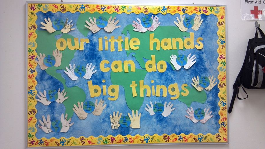 Preschool bulletin board displaying \'Our Little Helpers\' theme with children\'s roles and responsibilities