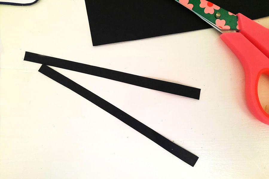 gluing stripes on bee puppet