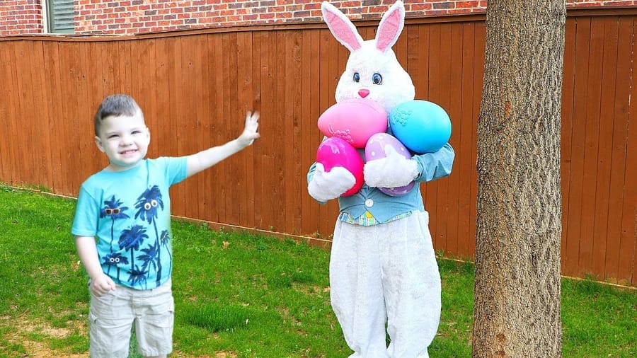 Preschool children joyfully playing with handmade Easter Bunny puppets