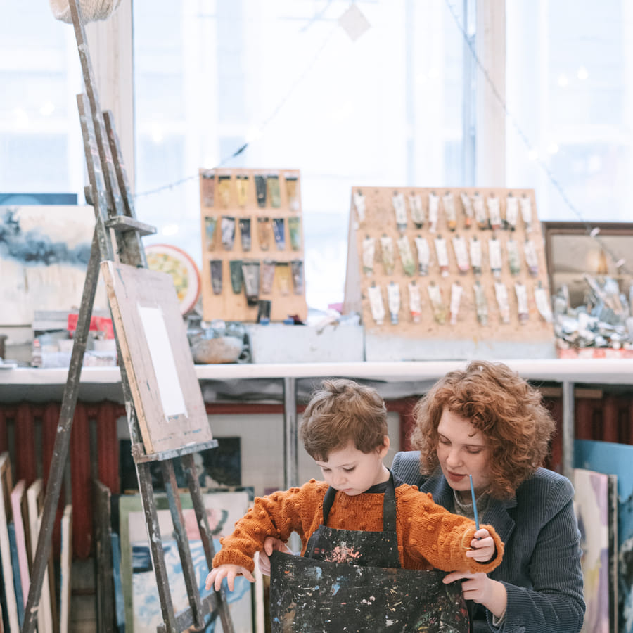 Preschool children happily participating in a craft activity related to their graduation song