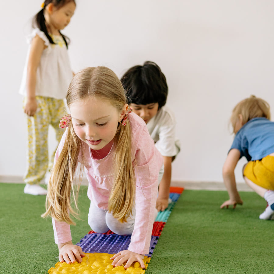 Preschool children laughing and learning with letter recognition activities